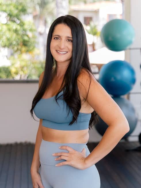 Natalie Suppa wearing fitness clothes in an indoor gym