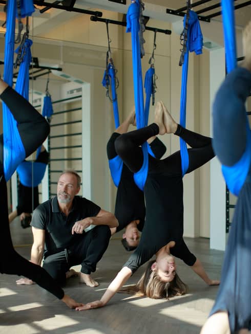 Guests doing anti-gravity yoga.