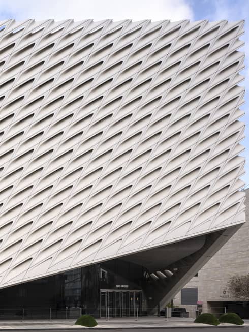 Large triangular shaped building with a diamond shaped design, the sky in the background