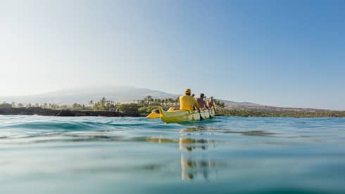 A group of guests take a canoe out on the water