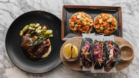 A variety of food on plates and trays.