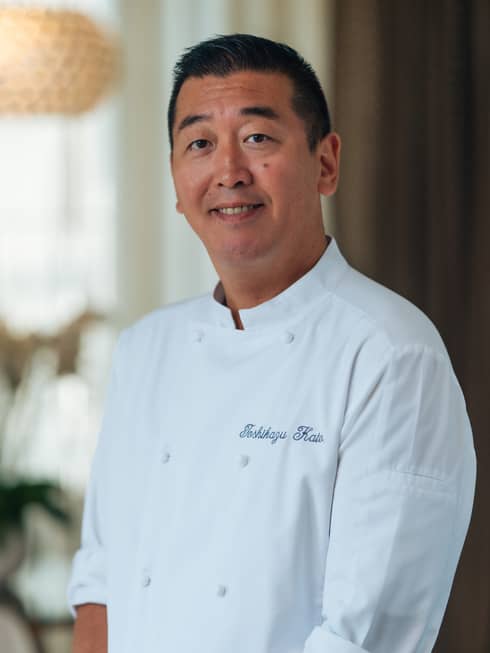 Chef Toshikazu Kato in white chef?s coat, smiling