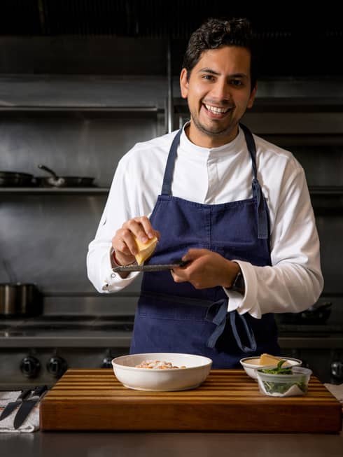 Chef Jesus Medina preps food in a kitchen