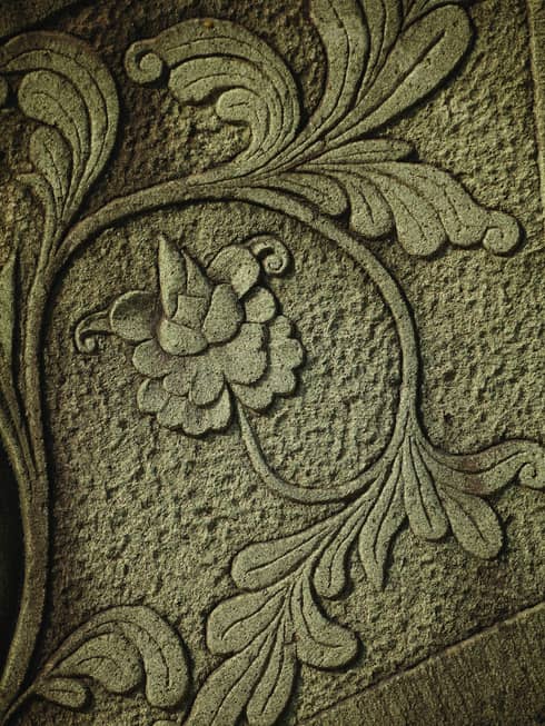 Intricate flowers and vines carved into concrete