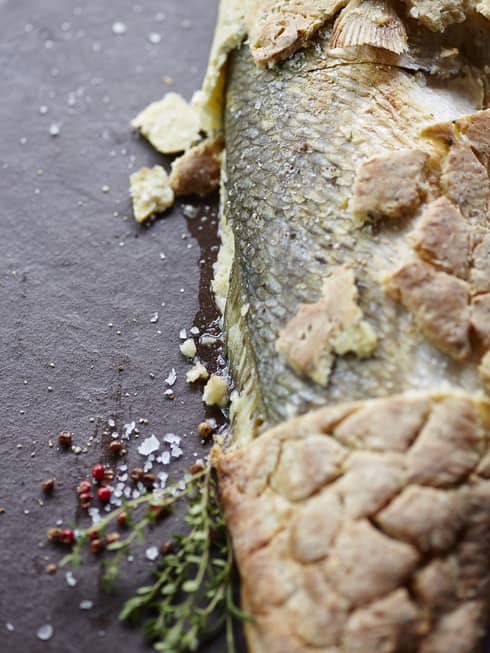 Salt-crusted fish garnished thyme