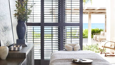 A spa room with a large window open to the outside and natural lighting.