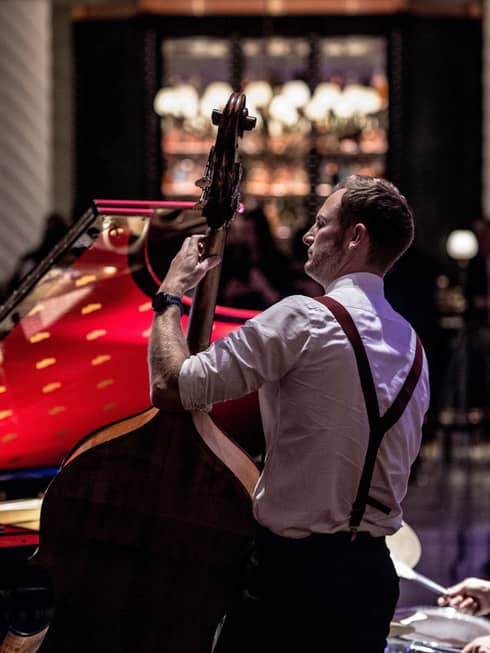 Bond Street Band, back of musician wearing suspenders and holding upright bass