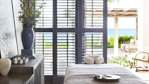 A spa room with a large window open to the outside and natural lighting.