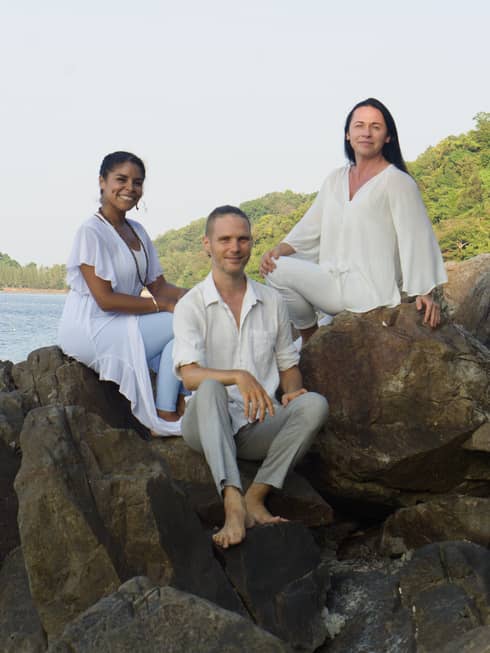 Sound therapists Svetlana Kaivalya, Dmitry Vrubel and Valerie Alken posed on top of rocks by the beach