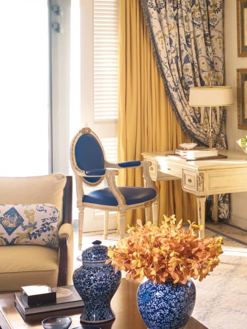 Sea-View One Bedroom Suite table with blue-and-white vases, cherry-wood dresser, flat-screen TV