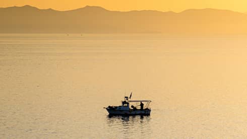 A boat on water at sunset