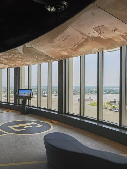 A large space with large windows looking out at a river.