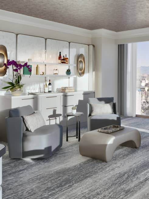 Sitting area set next to a buffet and artwork in a luxury suite at Four Seasons Hotel Las Vegas