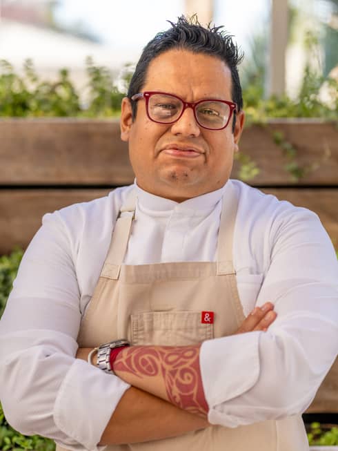 Hugo Bola�os wearing a chef?s coat and apron