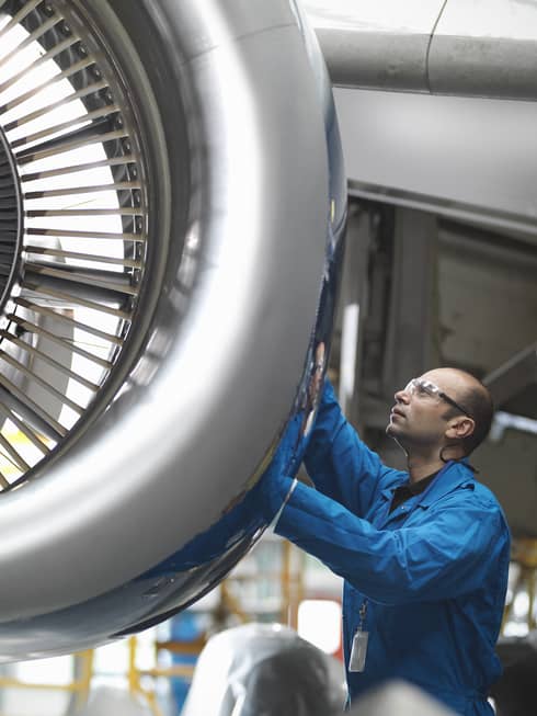 Man works on an airplane jet
