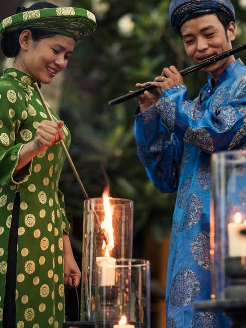 Two staff members complete the resort illumination ceremony by lighting candles with music