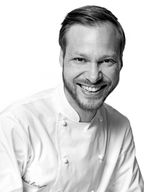 Black and white portrait photo of Chef Michaël Bartocetti in uniform