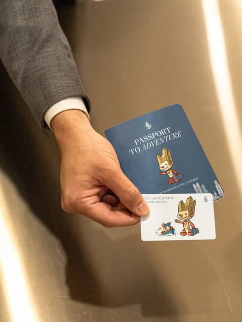 Person holding a passport and card.