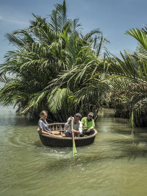 Guests paddle around Hoi An in a basket boat tour
