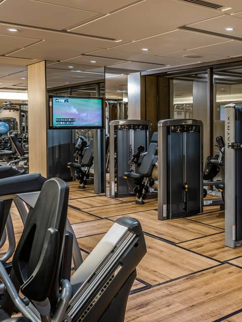 Cardio bikes, weight machines in front of glass wall in Fitness Centre