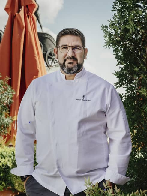 Chef Dani García in white chef’s coat with Four Seasons logo