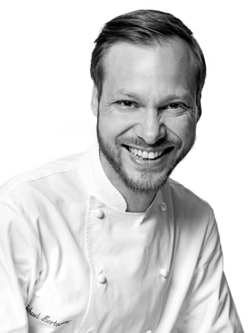 Black and white portrait photo of Chef Michaël Bartocetti in uniform