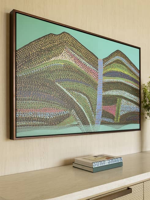 Contemporary resort suite hallway featuring an abstract Hawaiian painting above a dresser