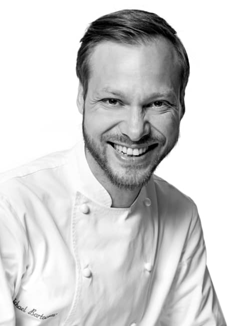 Black and white portrait photo of Chef Michaël Bartocetti in uniform