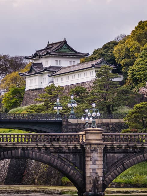 Historic brick bridge, Otemachi building tucked in hillside and trees