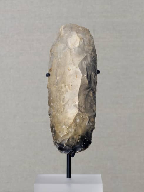 Flint adze artefact on display pedestal