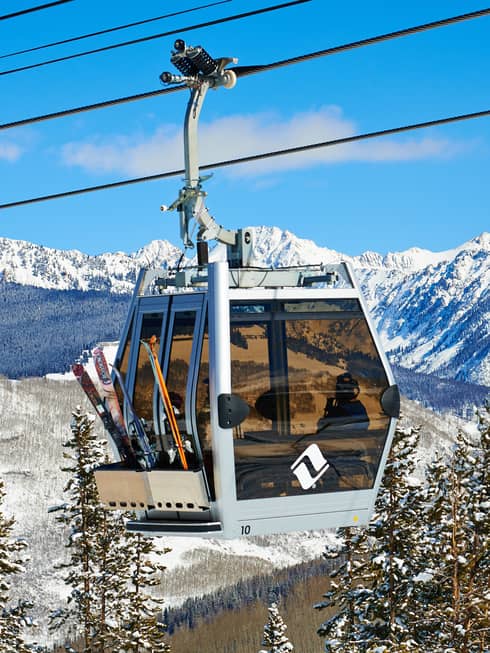 Ski lift heads uphill on snowy Vail, Colorado mountain