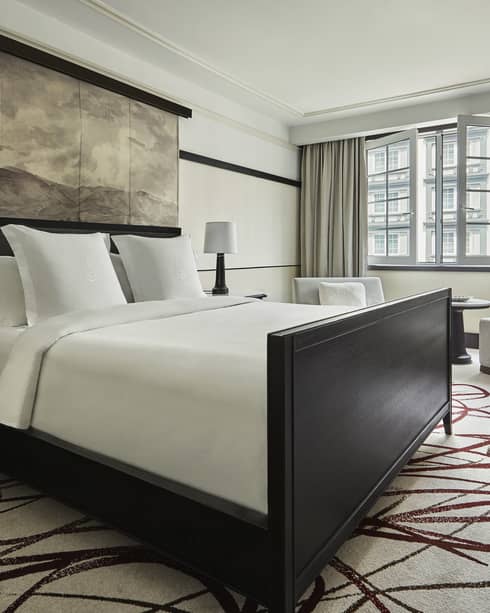 Bedroom with king bed, dark wood bed frame