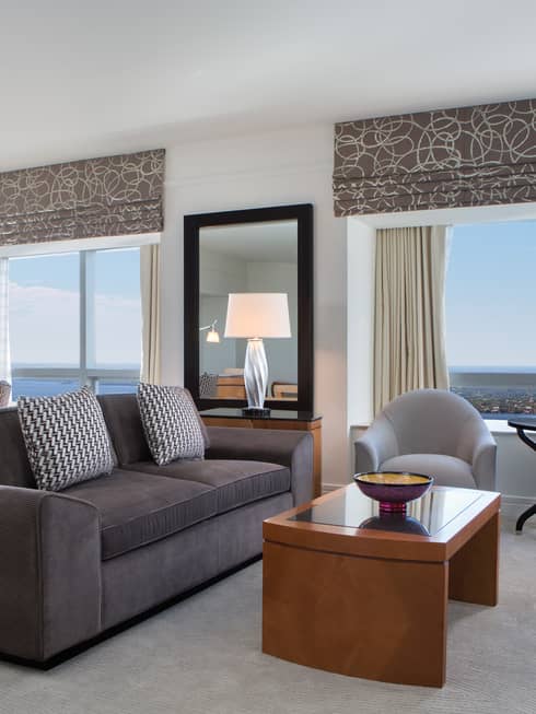 Grey sofa, armchairs in corner suite with large windows