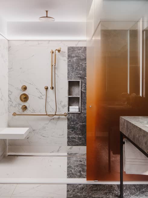 Marble bathroom with mobility-accessible shower