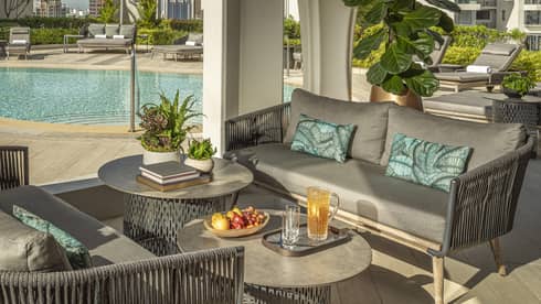 View of 20th-floor from outdoor lounge with grey poolside furniture