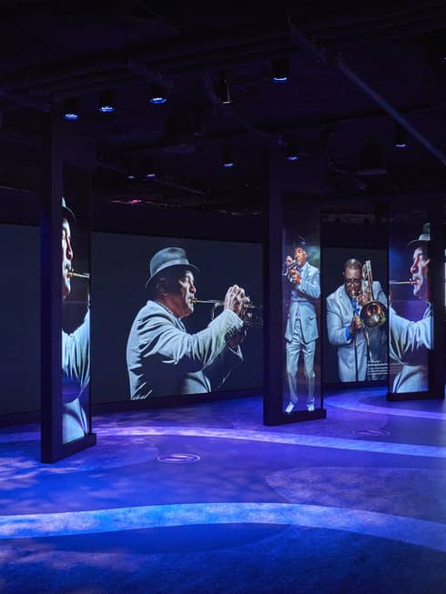 Large images of jazz musicians above a colourful floor.