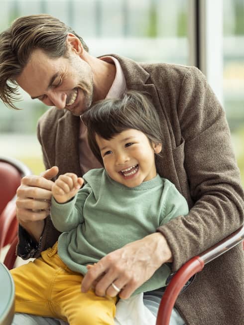 Laughing couple and kids enjoy a meal together