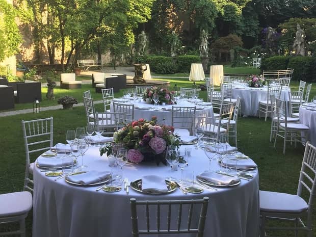 Outdoor banquet with round dining tables on lawn