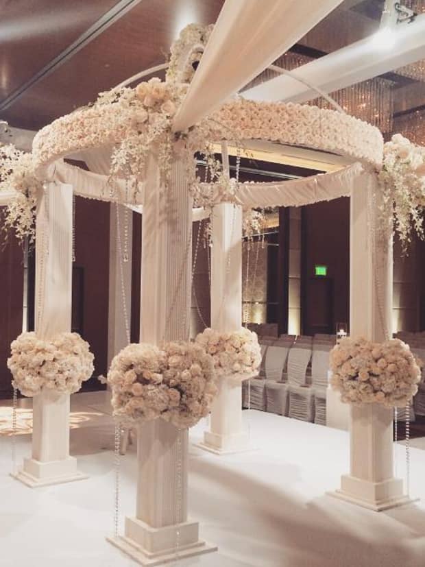 Wedding altar with white flowers covering pillars