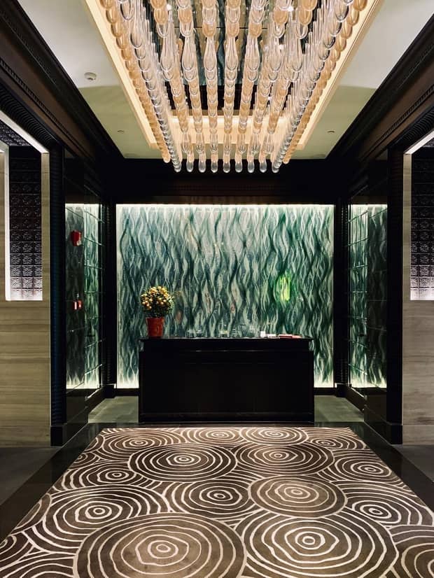 Event room, crystal lights over spiral patterned carpet and reception desk