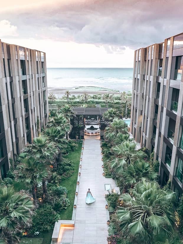 Aerial view of woman walking down pathway in Four Seasons Hotel Casablanca courtyard