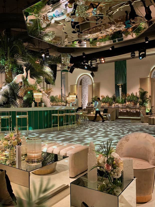 Wedding reception event room seating area, bar with white birds decor, mirror over dance floor