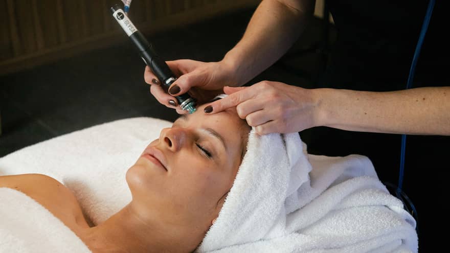 Woman on spa treatment table gets a Hydrafacial