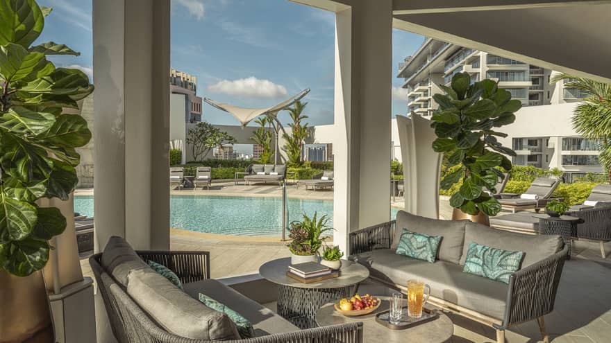 View of 20th-floor from outdoor lounge with grey poolside furniture