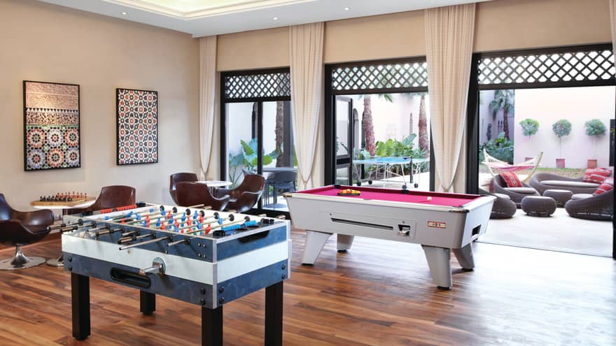 Games tables in Young Adult Centre room with open doors to patio