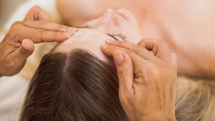 A guest is treated to a calming facial at the spa
