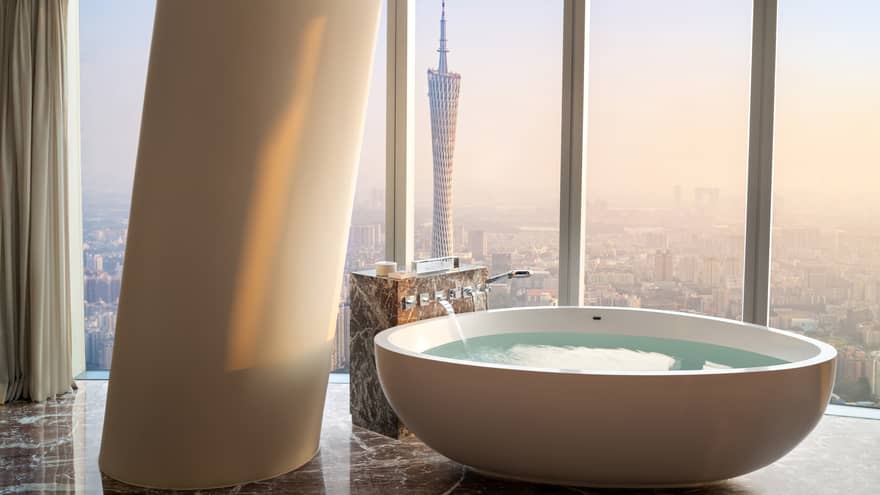 Deluxe Twin Canton Tower View Suite soaking tub with floor-to-ceiling windows