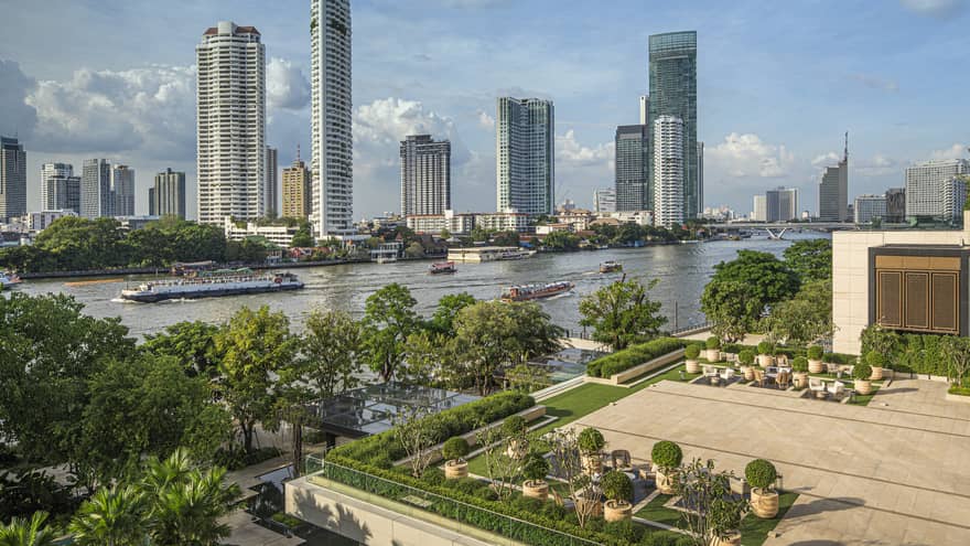 Outdoor terrace with landscaping around edge, view of Chao Phraya River in Bangkok
