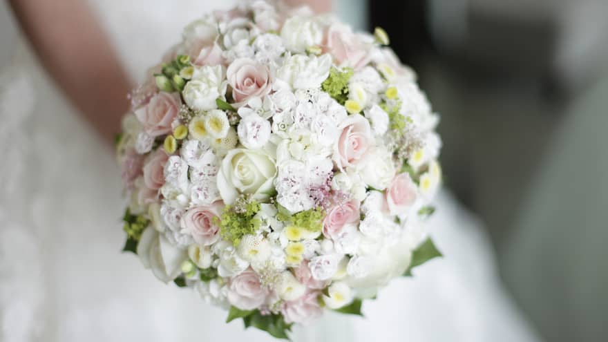 Round floral wedding bouquet with small white and pink roses