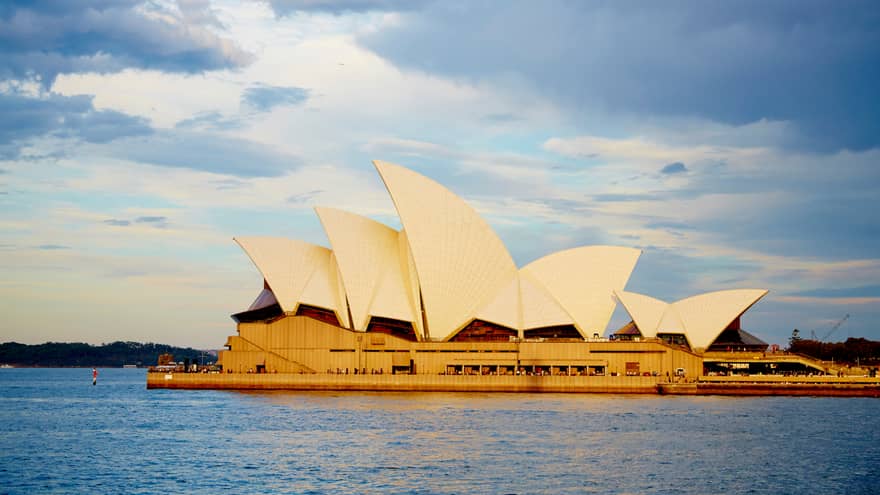 View of Sydney Opera House with its white, sailboat-like roof from harbour
